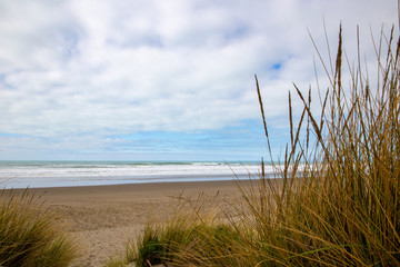 Fototapeta na wymiar A calm beach view on a cloudy day along the east coast in New Zealand
