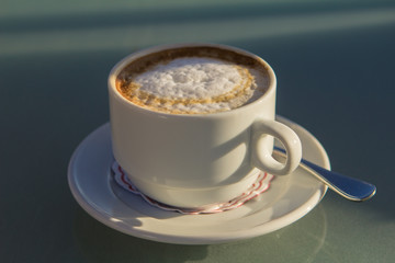 white cup of coffee on the table at sea. Summer holiday concept.