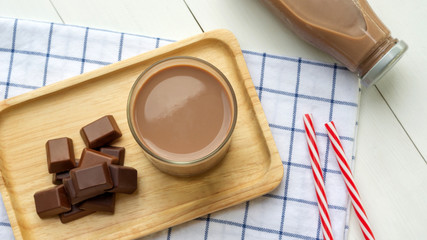 Chocolate milk on a white wooden table.