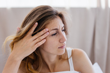 Fototapeta premium a portrait of a woman stretching in bed after wake up