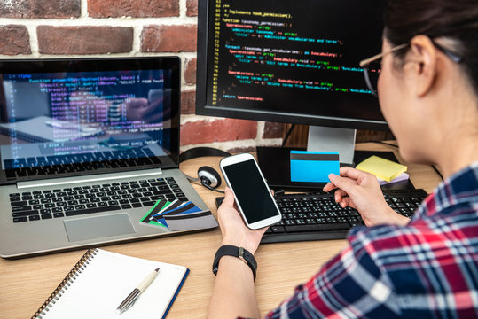 back view of using a credit card and smartphone