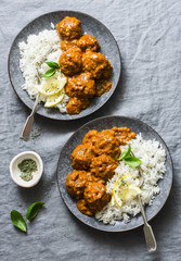 Lentils vegetarian roasted meatballs with curry sauce and rice - healthy lunch on grey background,...