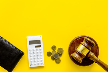 Financial failure, bankruptcy concept. Judge gavel, wallet, coins, calculator on yellow background...
