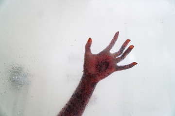 Creepy hand behind glass bathroom window