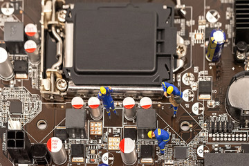 Miniature Group Engineers inspecting computer processor with chip and repairing maintenance circuit...