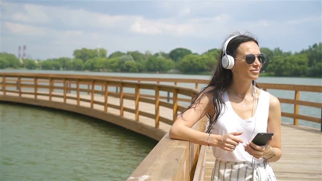 Happy young urban woman enjoy music outdoors