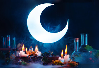 Halloween header with shining full Moon. Witch or wizard workplace with burning candles. Spooky...