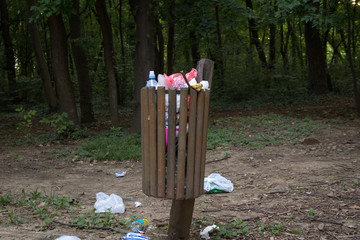 Filled trash can. Pollution