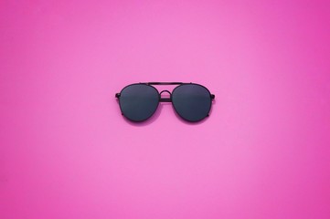 top view sunglasses on colorful background.