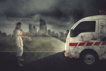 Scary zombie man hindering an ambulance car © Creativa Images