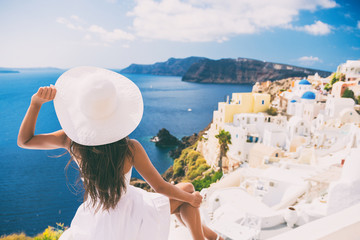 Tourist woman at view of Santorini cruise travel. Beautiful white village of Oia with Caldera and...