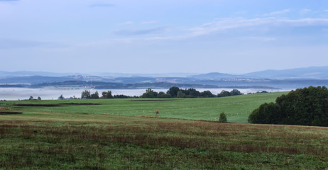 Obraz premium Meadow with morning fog and hills, Czech landscape