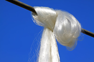 Suspension of fishing nets in the blue sky
