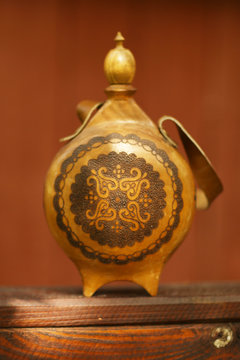 antique lether flask with pattern engraving and belt