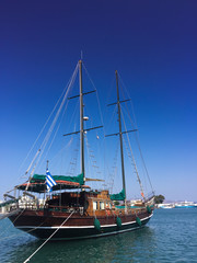 Fototapeta na wymiar Greek antique style sailboat docking in the port