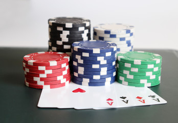 The pile of casino chips with cards.