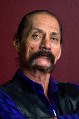 Fototapeta premium Portrait of a Rough and Distinguished Man with a Thick Mustache and Piercing Blue Eyes