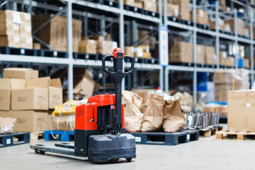 Rows of shelves with boxes in big modern warehouse