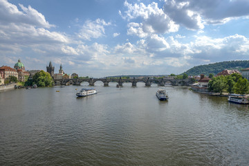 Fototapeta na wymiar Beautiful summer day, Vltava river, ships and old city center, Prague, Czech Republic. Charles Bridge
