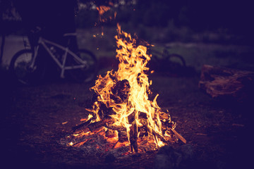 Campfire and bicycles in the background