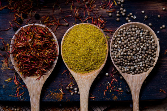 Coloful Various Spice And Herbs In Wood Spoon On Natural Texture Wood Plate.