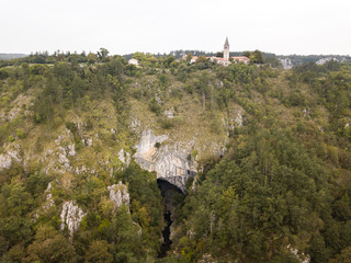 The Skocjan Caves / Skocjanske jame / Grotte di Skocjan is the largest cave in Europe on UNESCO list. The enterance is a huge collapse sinhole / doline below the church of St. Canzian (Kancijan) 