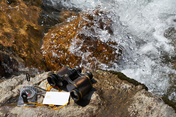 Picture of vintage binoculars, bank card and compass.