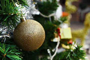 Christmas and New Year decorations golden and silver colors on a fir tree.