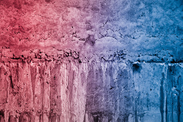 Textured broken cracked concrete wall, grunge background, red blue background