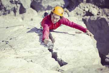 Rock climber on a face of a cliff