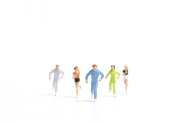 Miniature people running on white background , Healthy lifestyle and sport concepts.
