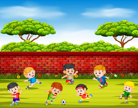 the children playing soccer with their team together in the yard 
