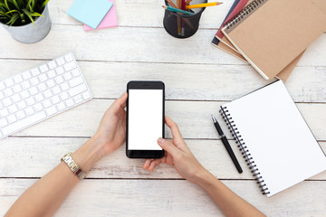 hand woman using a telephone, empty screen smart phone and computer on wooden table In home office. with clipping path