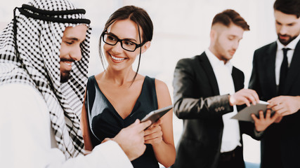 Girl Talking With Arab About Business Partnership.