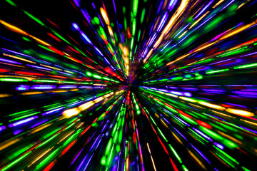 Diagonal blurred lines of color lights is converged on dark background. Colorful lights blurred by motion.