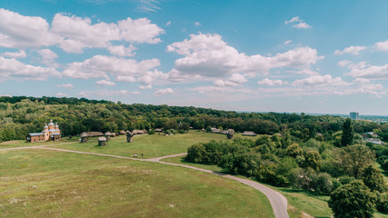 Aerial view of the field. Ancient houses. Mills. Summer. Sky. Forest. Trees. Kiev (Kyiv). Ukraine.