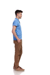 Fototapeta premium young casual man with hands in pockets waiting in line