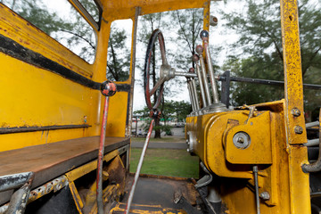 Road grader parking..Closeup control room of discharge old construction machine with steering wheel parking in public park for children playground.