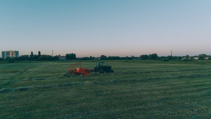 Naklejka premium Aerial view of the tractor in the field. Harvesting. Ukraine.