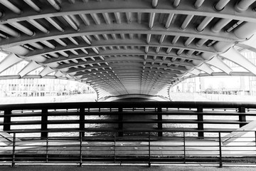 crown prince bridge (german Kronprinzenbruecke) from below in black and white, the road bridge crosses the river spree in berlin and connects the government quarter with the Tiergarten district.