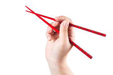 Hand with red chopsticks isolated on a white background