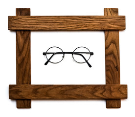 Round glasses with transparent glasses in a wooden frame on a white isolated background.