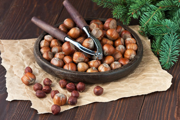 Heap of hazelnut on  wooden table with nutcracker