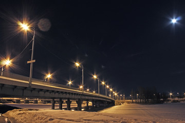 lights at night in winter on the background of the bridge with bokeh