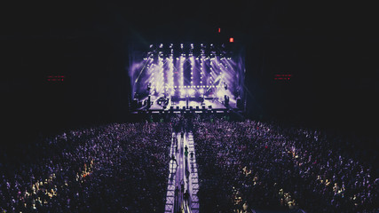 Aerial view on the stage. Music Festival. Crowds of people. Evening. Night. Dark.
