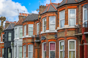 Fototapeta na wymiar A row of typical red brick British terraced houses in London