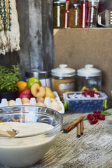 Food ingredients and kitchen utensils for cooking desserts on wooden background