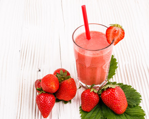 fresh strawberrysmoothie or milkshake on a wooden rustic background