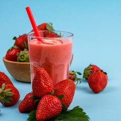 fresh strawberrysmoothie or milkshake on a delicately blue background