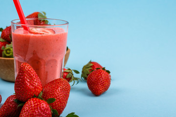 fresh strawberrysmoothie or milkshake on a delicately blue background